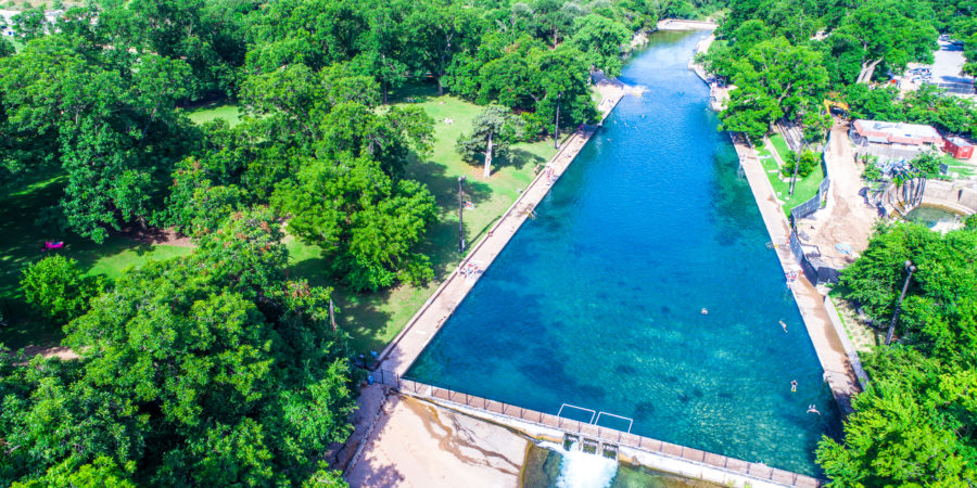 Looking across the Barton Springs Swimming Hole Turquoise Blue clear Spring water natural summer escape